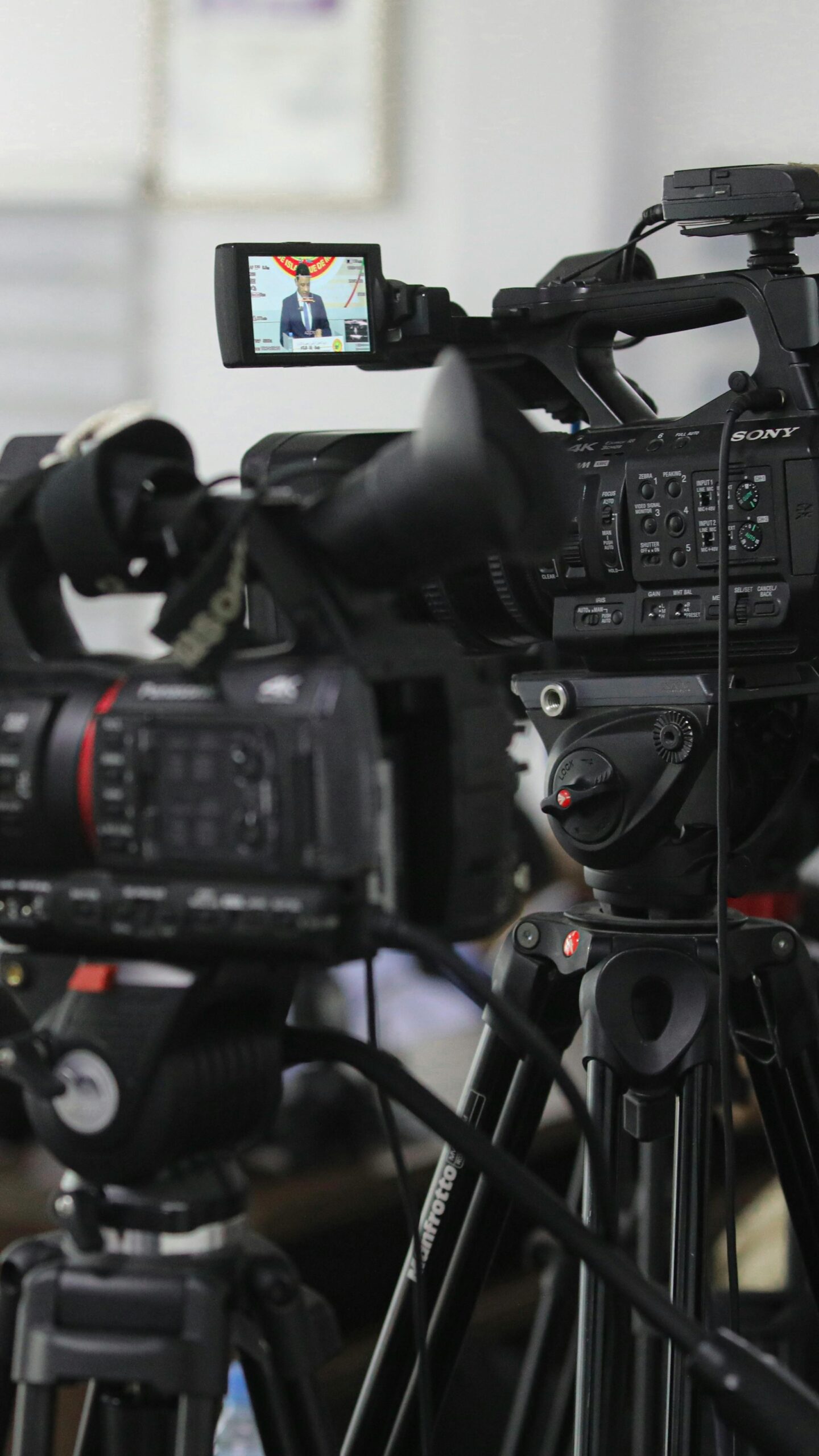 Close-up of professional video cameras set for filming indoors.
